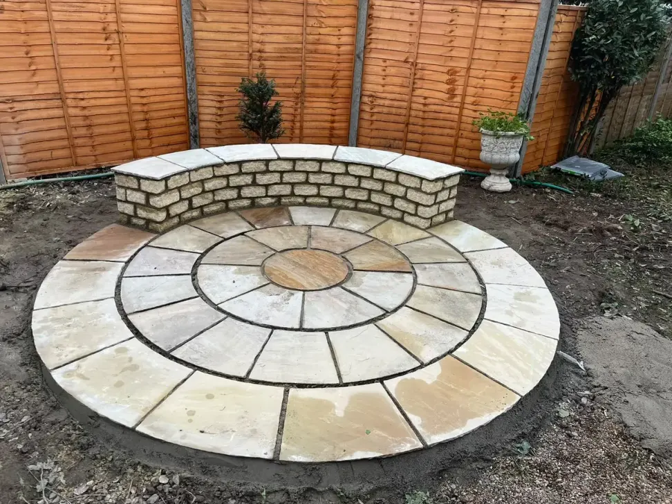 Sandstone circle patio feature with curved brick seat